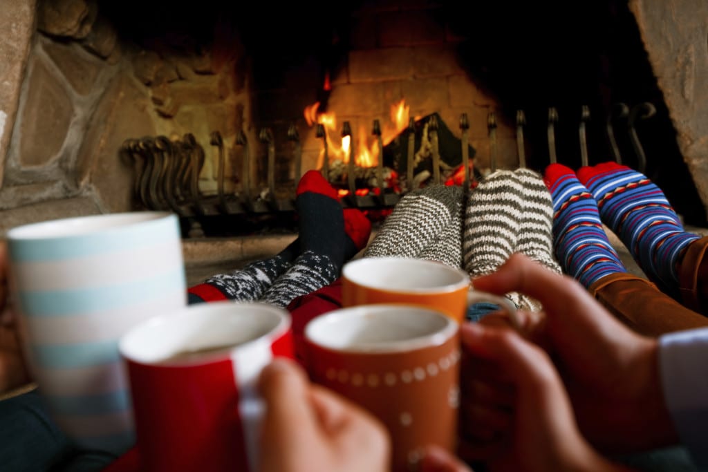 Friends sitting by the fireplace